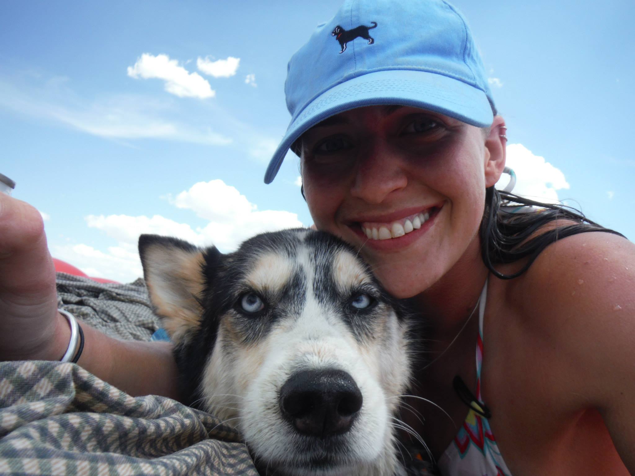 Photo of Jennifer Webster at the beach with her husky 