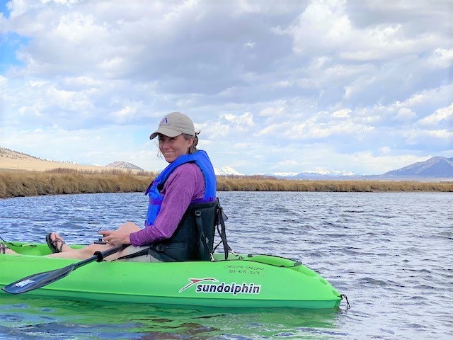 Photo of Meg Druyor kayaking on a mountain lake