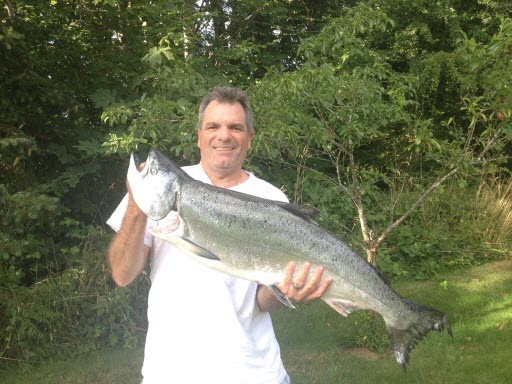 Photo of Tim Smith holding a large salmon fish