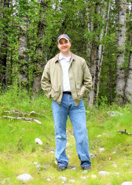 Photo of Dan Hogan standing in a forest